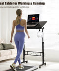 Total Game Changer Small Height Adjustable Standing Desk With Tiltable Tabletop And Smooth Rolling Wheels Customized For Remote Workers And Gamers Who Want Flexible Setup Vibes And Rock Solid Stability with a laptop and headphones.