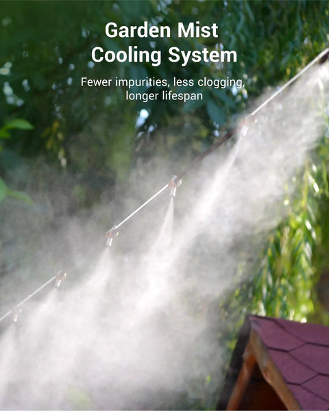 Garden hose mist cooling system in operation, reducing impurities with visible mist spray nozzle, forest background.