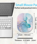 Compact 6x7 Inch Mouse Pad For Laptop And Keyboard Tray, Cyan Blue Marble design next to laptop, showing non-slip rubber base, 3mm thick