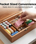Hand placing pink magnetic seam guide with thread trimmer in wooden sewing box for Seam Guide With Magnetic Alignment For Sewing Machines, Easy Clamp Tool For Precise Stitching, Keeps Cuffs, Pockets, And Hems In Line, Ideal For Beginners And Pros, Speed Up Your Sewing Projects And Achieve Pro Level Results.