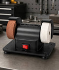 Badass Dual Wheel Bench Grinder With Sturdy Rubber Footed Base on a workbench, featuring dual wheels for polishing and sharpening.