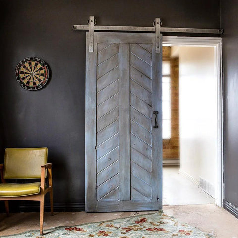 Six And A Half Inch Black Pulls Two Pack For Barn Doors installed on a wooden sliding door with vintage black handle