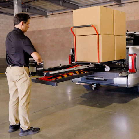 Heavy Duty Electric Scissor Lift Table 59 Inch Height Warehouse Workhorse loading cardboard boxes onto a truck.