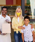 Smiling man holding a Bulk 500 Pack Heavy Duty Kraft Paper Bags 10x13 Inches With Handles, standing with woman and child.
