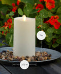 Outdoor Flameless LED Ivory Candle With Melted Edge, 3.75 x 7 Inches, Real Moving Flame on patio with flowers, Battery Powered.