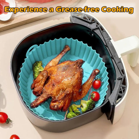 Round 8 Inch Silicone Air Fryer Liners 2 Pack Red And Cyan Nonstick Reusable Heat Resistant Dishwasher Safe For 3 Qt to 6 Qt Fryers Fits Most Brands Great For Any Countertop Setup with cooked chicken inside.