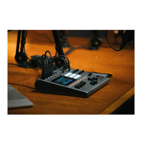PodTrak P8 Podcast Recorder With Six XLR Inputs Six Headphone Outputs on a wooden desk in a recording studio