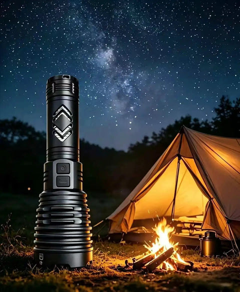 Ultra Bright 155,000 Lumen Rechargeable Flashlight With Zoomable Beam next to tent and campfire under starry sky