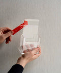 Applying VHB 4910F Clear Double Sided Acrylic Foam Tape for Transparent Bonding on a clear plastic holder, 1.0 mm thick, 19 mm x 11 m roll.