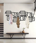 Slick Abstract Line Coat Rack Wall Mount With Integrated Key Holder Mid Century Modern Entryway Hooks For Jackets And Bags Fresh Black Metal Home Accent Vibe Solid Wall Storage Setup For Quick Daily Grabs with coats hanging.