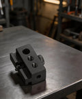 Heavy Duty Black Aluminum Igt Table Track Slider Clamp Mount With Triple Sized Ports displayed on a workbench.