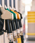 Fuel nozzles at a gas station, representing context for Five Sixteenth Inch Fuel Line Hose For Cars And Trucks, SAE 30R10.