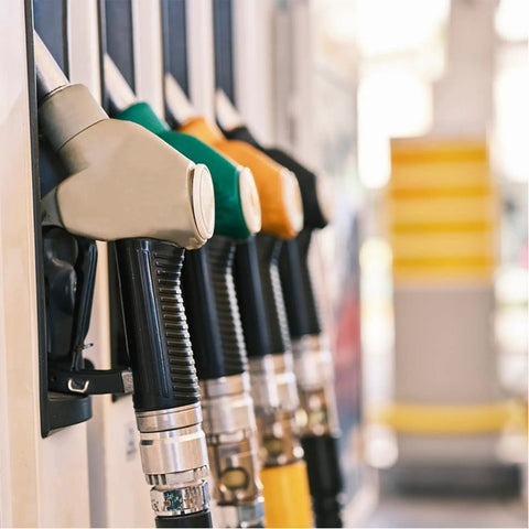 Fuel nozzles at a gas station, representing context for Five Sixteenth Inch Fuel Line Hose For Cars And Trucks, SAE 30R10.
