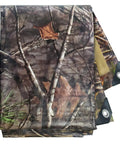 Tree camo No Nonsense Tough 9 Mil Tarp Cover Waterproof UV Resistant Tarpaulin for outdoor use, folded with metal grommets visible.