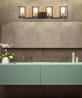 Farmhouse Style Four Light Vanity Fixture With Black And Antique Brass Metal Cage in modern bathroom setting