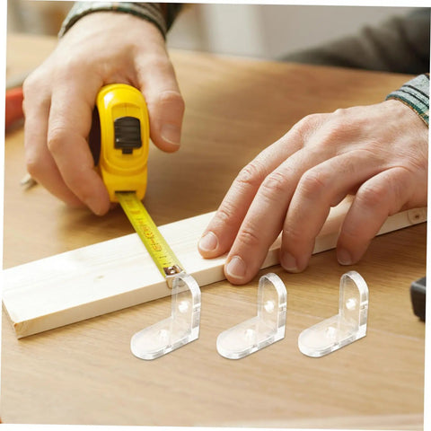 Man measuring wooden board with tape, showcasing 10 pcs clear acrylic corner brackets for furniture reinforcement, L shaped braces.