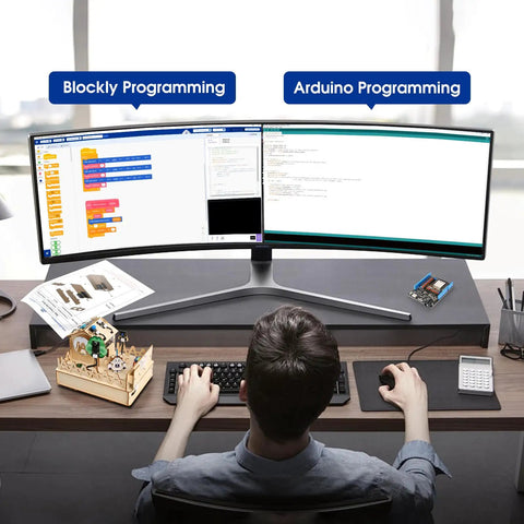 Teen programming ESP32 Smart Home IoT Starter Kit For Teens And Makers at desk with dual monitors showing Blockly and Arduino IDE.