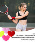 Woman playing tennis with heart shaped tennis dampeners set of 4 silicone vibration absorbers for rackets in colorful hues with text.
