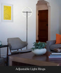 Halo Split LED Torchiere Floor Lamp with adjustable rotating light rings in a modern living room setting, showcasing Jet Black finish.