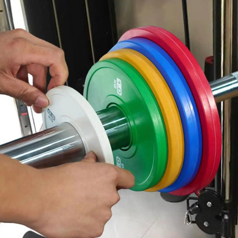 Loading a 0.5 Kg Barbell Change Plate With Grooved Inner Design onto bar, white finish, for stable lifts, home gym setting