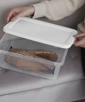 Clear Plastic Storage Bins With Lids 6 Quart Stackable Organizer Boxes For Closet Organization with shoes inside.