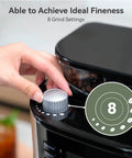 Close-up of hand adjusting dial on Electric Coffee Grinder With 35 Grind Settings For Espresso, Drip, And French Press, Black