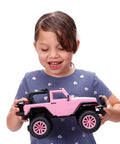 Girl holding Jeep Wrangler 1:16 RC Car For Kids With 2.4GHz Remote, Full Function Ride With Turbo Boost, Pink Toy For Girls, isolated.