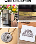 Laser marking spray sample set: stainless mug, brass name plate, silver lion pendant, and white tile with engraving.