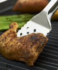 16-Inch Stainless Steel Tong And Turner Combo With Red Soft Grip Inserts holding grilled chicken on barbecue