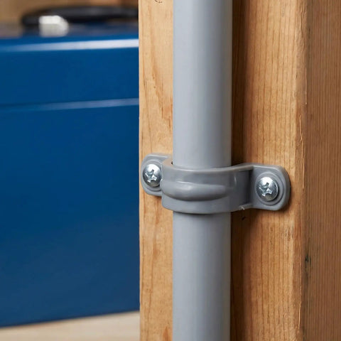 Thirty Pack Real Heavy Duty Three Quarter Inch Pvc Conduit Clamps mounted on a wooden post, securing a gray conduit pipe.