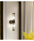 Modern Black Wall Sconces Bring A Smooth Chill Vibe With Classic Glass Shades Perfect For Bedroom Bedside Living Room Or Hallway Decor Glare Free Minimalist Indoor Lighting Solid Build Zero Hassle Setup, featuring tall glass shade and bronze mount.