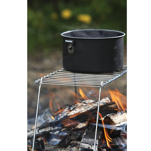 Pack Grill Ultra Lite Lightweight Portable Stainless Steel Camp Grill with pot over open fire, folds flat for easy storage.