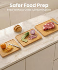 Heavy Duty 3 Piece Bamboo Cutting Board Set With Wooden Stand For Everyday Kitchen Tasks with sliced vegetables and meat.