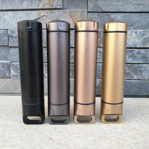 Assorted colors of Portable Survival Waterproof Pill Container for Outdoor EDC Gear, CNC machined aluminum bottles on stone background.