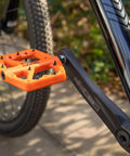 Ultra Lightweight Mountain Bike Pedals With Grippy Traction For Trail And BMX Rides Platform Pedals Nine Sixteenth Inch Axle Nylon Fiber Build Durable And Lightweight Orange installed on bike