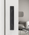 4 Pack Black Zinc Alloy Barn Door Handles Set With Mounting Plates installed on a white sliding door in a modern living room.