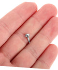 Close-up of a single silver iron brad from 100 Pcs Iron Brads For DIY Crafting And Puppet Making Kit Durable Metal Fasteners For Paper Embellishments.