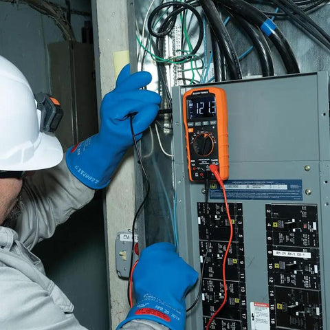 Rugged Digital Multimeter With Auto-Ranging TRMS LoZ Ghost Voltage Elimination in use on electrical panel by technician.