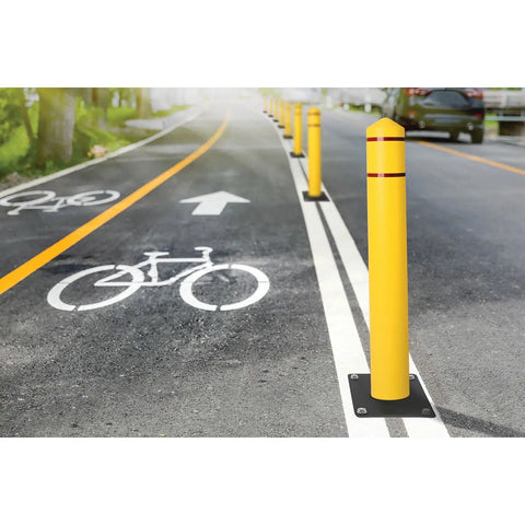 Heavy Duty Bollard Covers For Four Inch Outdoor Poles Fifty Six Inch Tall Post Sleeves protecting bike lanes with bright yellow poles on a road.