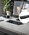 Built Tough Ergonomic Keyboard Tray Under Desk Slide Out Platform With Adjustable Tilt Angle Black Pp on a white desk with keyboard.