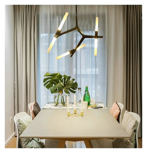Sleek Modern Herringbone Pendant Light With Dimmable Led G9 Fixtures Heavy Duty Iron Build For Contemporary Living Rooms And Dining Spaces stylishly illuminating a dining table with greenery.