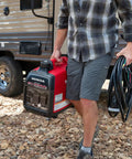 Person carrying Smooth Operator 2200 Watt Portable Inverter Generator 120 Volt Output featuring Smart Co Minder safety tech.