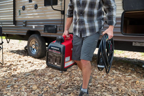 Person carrying Smooth Operator 2200 Watt Portable Inverter Generator 120 Volt Output featuring Smart Co Minder safety tech.