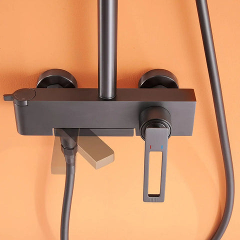 Close-up view of the Wall Mounted Exposed Shower System with Tub Spout 90° Rotating Gun Gray faucet control and hoses.
