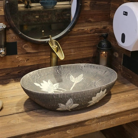 Built Tough 22 X 14 Oval Ceramic Vessel Sink Delivering Chinese Antique Charm And Easy Peasy Cleanup, set atop wooden counter.
