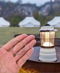 Bingche 40 Pcs Flush Mount Conversion Kit Clips for Drum Lampshade Silver Drill Organizer held in hand near a lit lantern outdoors.