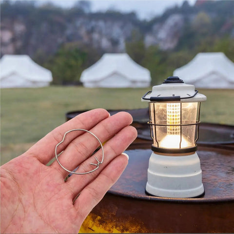 Bingche 40 Pcs Flush Mount Conversion Kit Clips for Drum Lampshade Silver Drill Organizer held in hand near a lit lantern outdoors.