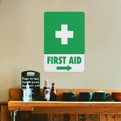 Right Arrow Green First Aid Sign 8x12 Inches Weatherproof Reflective Aluminum Plate on interior wall of a cafe.