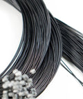 Close-up of black Teflon Shift Cable Inner Derailleur Cables for Mountain Bike Road Bike BMX with end caps visible