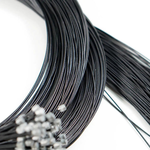 Close-up of black Teflon Shift Cable Inner Derailleur Cables for Mountain Bike Road Bike BMX with end caps visible